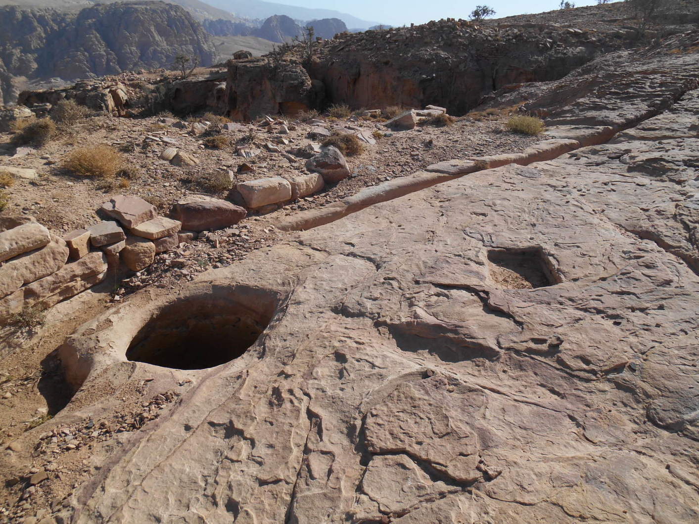 Hewn into Umm Al-Biyara’s summit are openings for the many cisterns that were used by the mountain’s ancient inhabitants to capture and harvest precious winter rains. But for the modern visitor trekking across the summit, the simple, often concealed openings also present dangerous hazards. Photo by Wiebke Lepke.